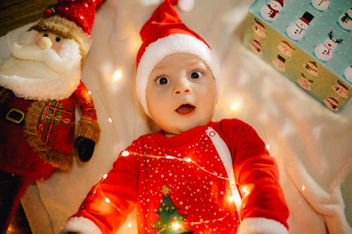 A Baby in a Red Christmas Romper