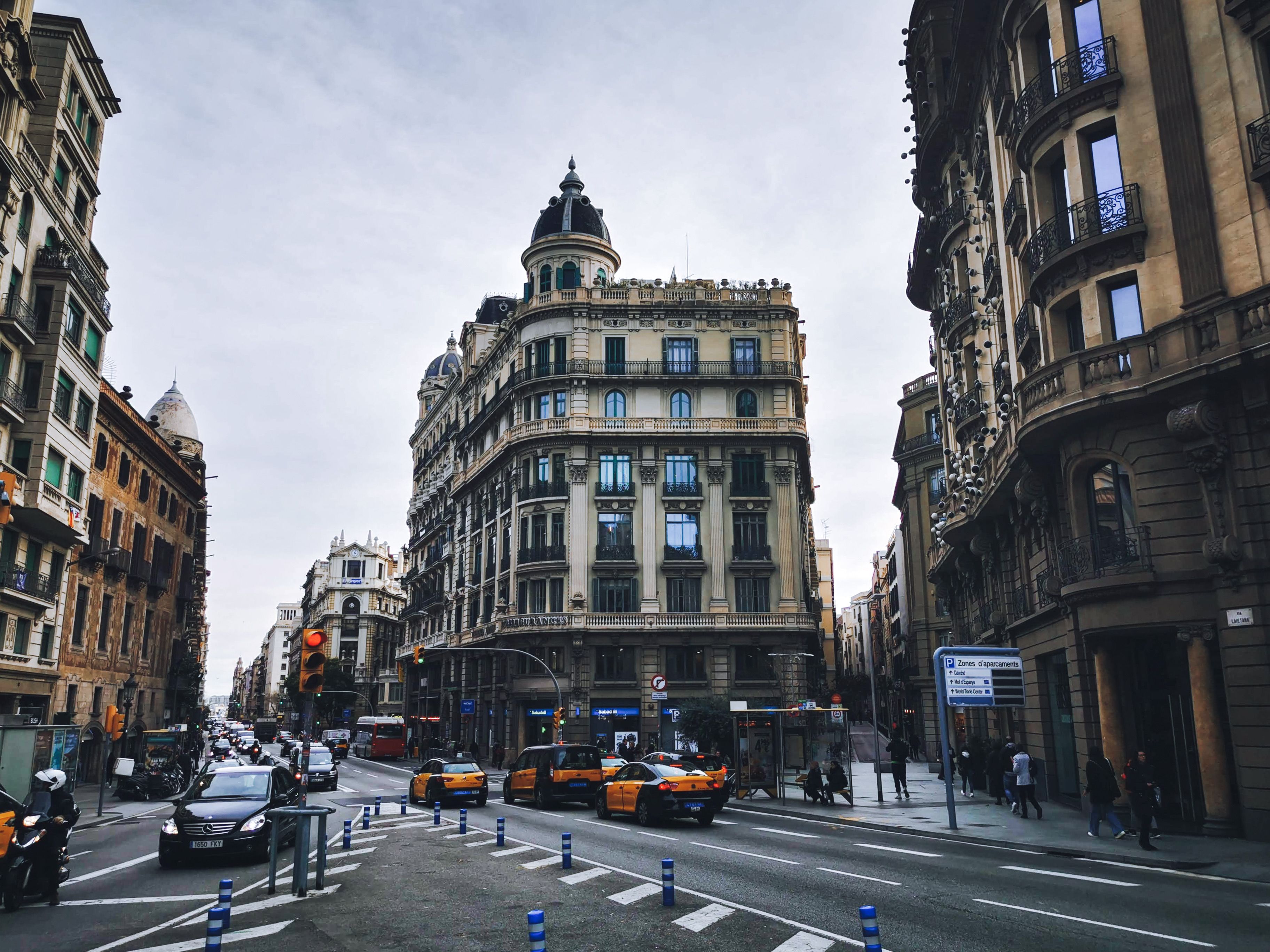 Historic street view of Barcelona's urban intersection with traditional architecture and traffic.