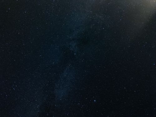 Free A breathtaking view of the starry night sky featuring the Milky Way galaxy amidst countless stars. Stock Photo