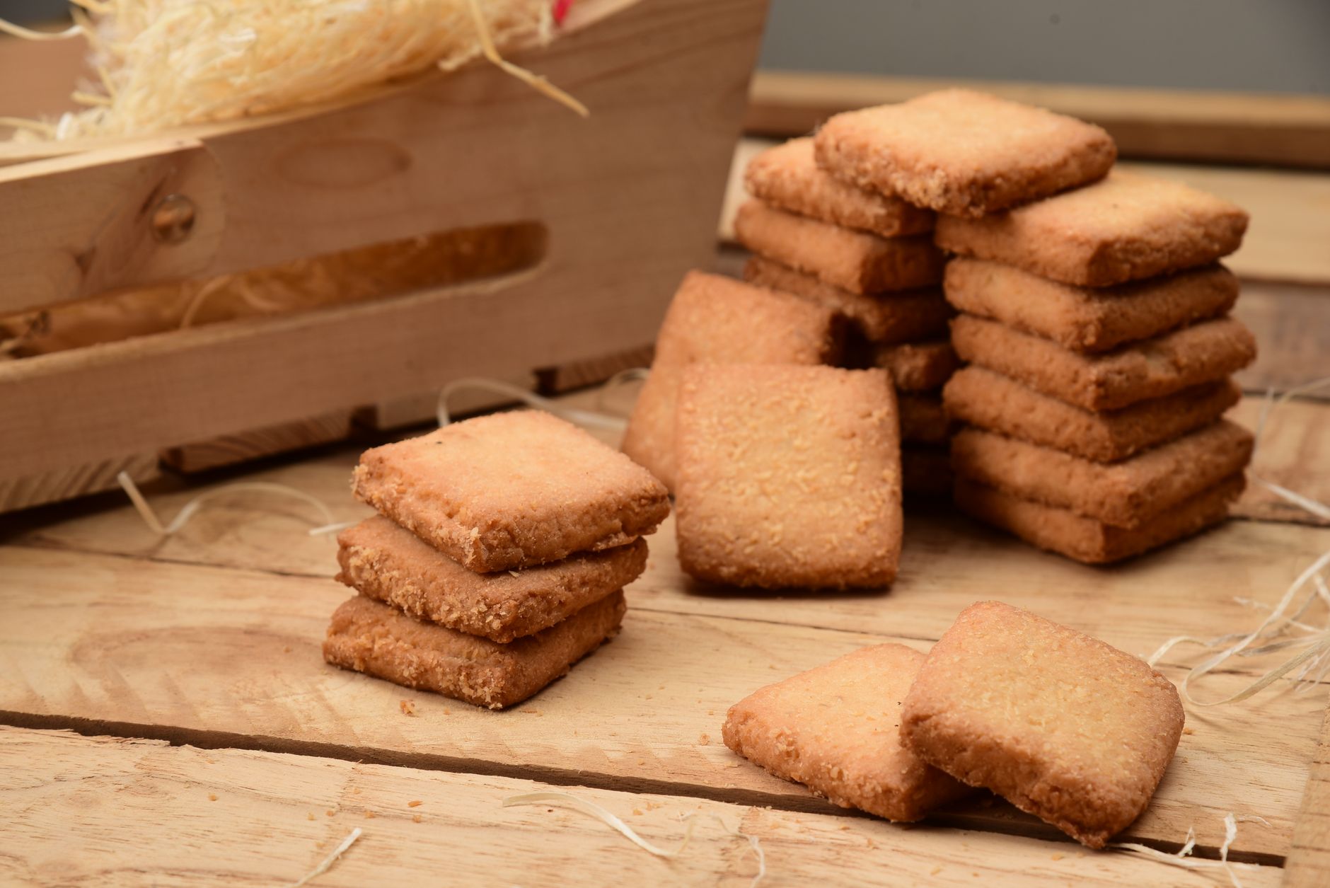 Stack of crisp shortbread cookies on wooden board