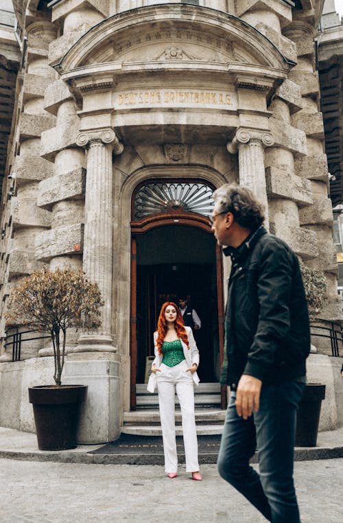 People Standing Near the Entrance of an Old Concrete Building