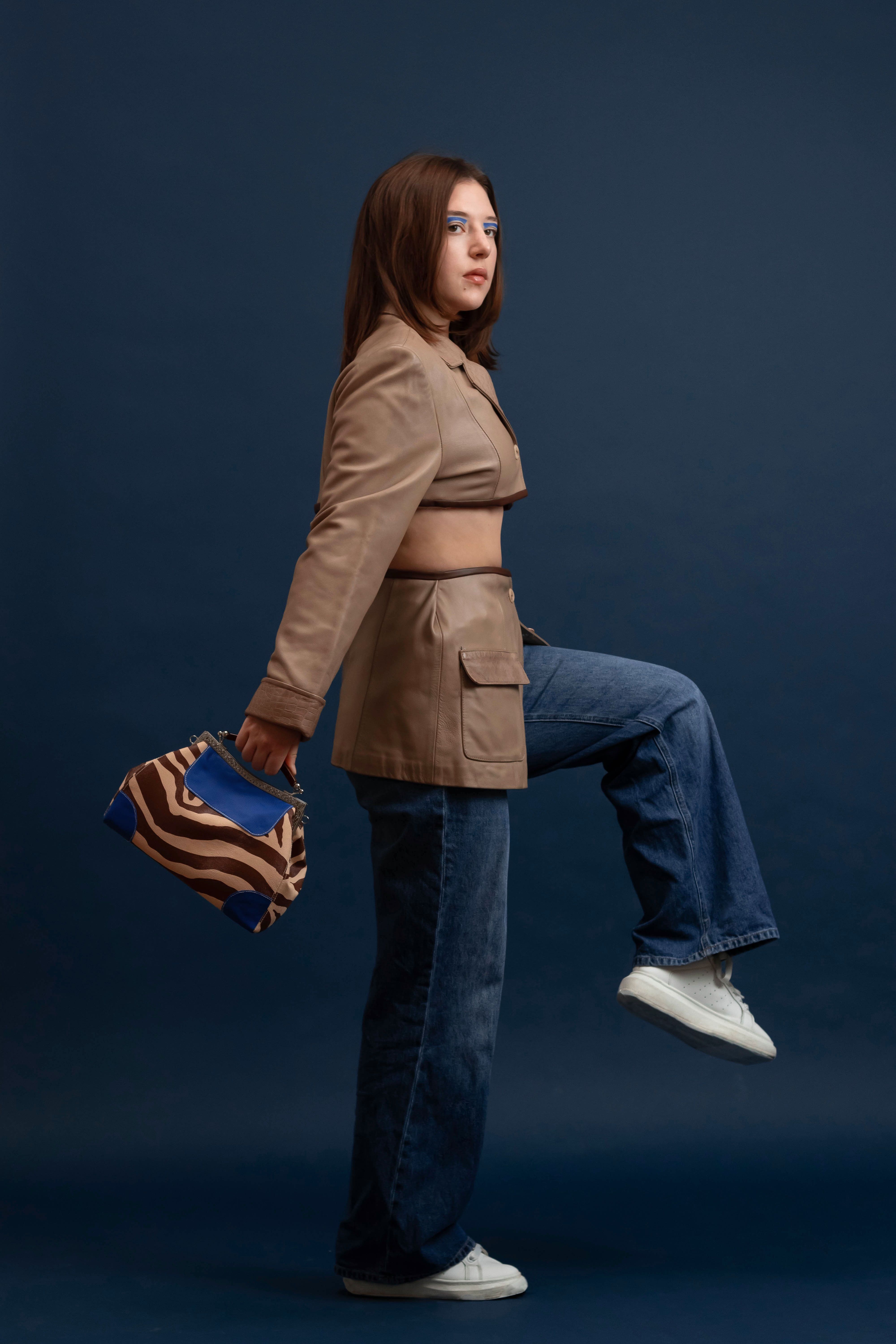 Side View of a Woman in a Brown Coat Walking · Free Stock Photo