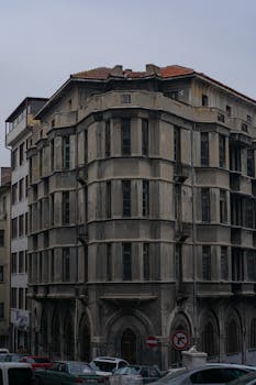 Explore the intricate facade of a historic building on an overcast day in Ankara, Türkiye.