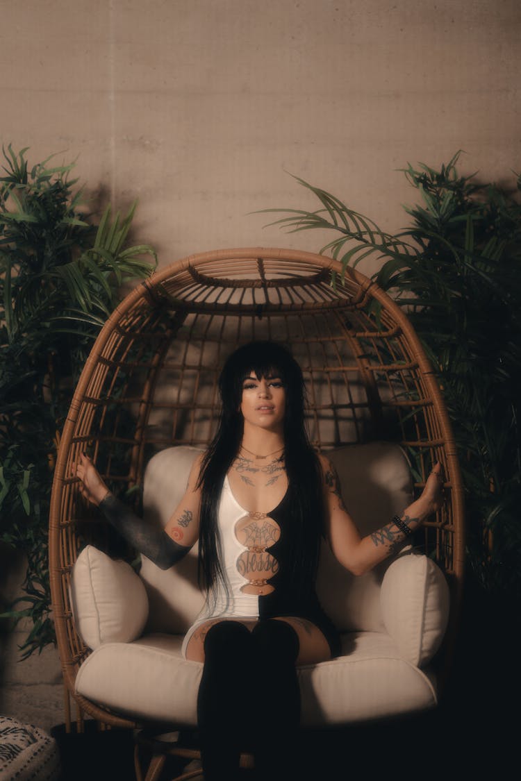 Woman With Black Hair Posing On Armchair