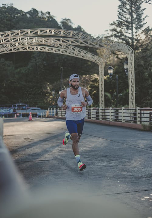 Man in Sportswear Running on a Marathon Race