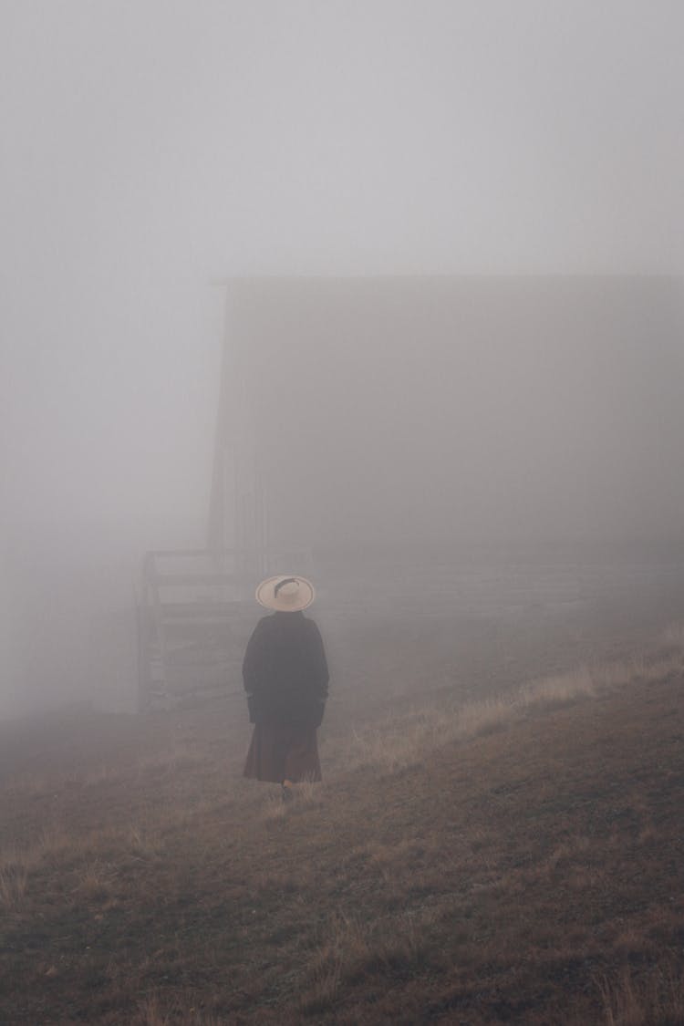 A Person Standing In A Fog