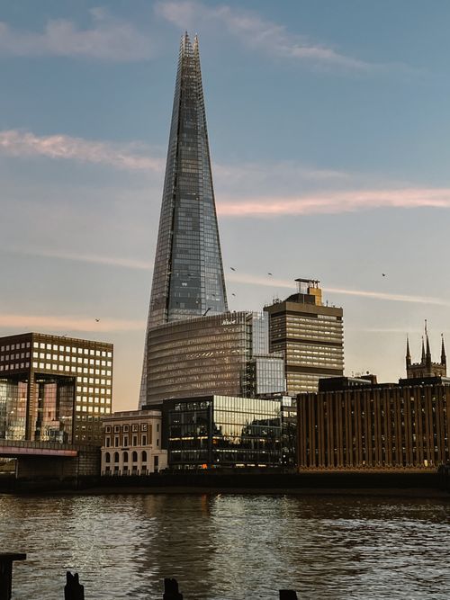 Free Beautiful view of the Shard in London's skyline during sunset, reflecting on the Thames River. Stock Photo