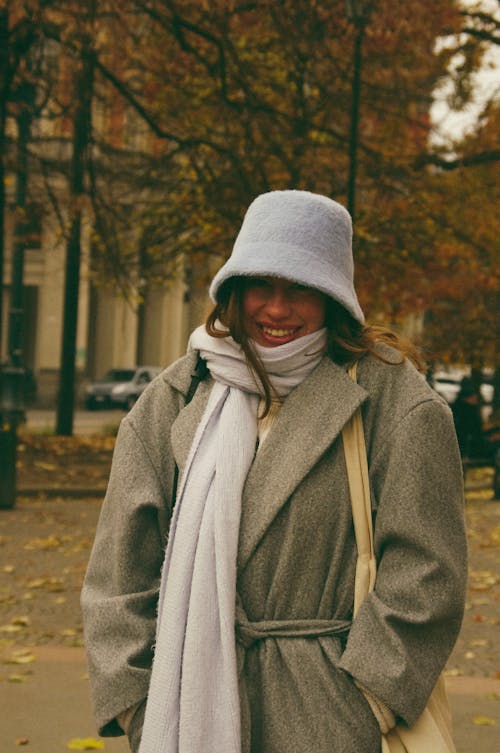 Smiling Woman in Winter Clothing on the Street