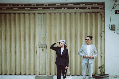 Couple Looking Out in Front of an Entrance Gate