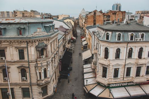 Aerial view of a historic street lined with European architecture in Bucharest's old town.