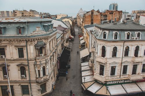 Free Aerial view of a historic street lined with European architecture in Bucharest's old town. Stock Photo