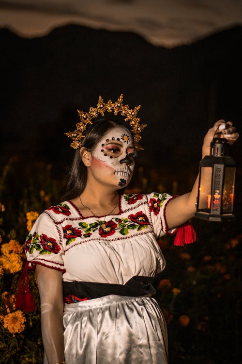 Woman Wearing Costume and Makeup for the Day of the Dead Celebrations in Mexico and Holding a Lantern 