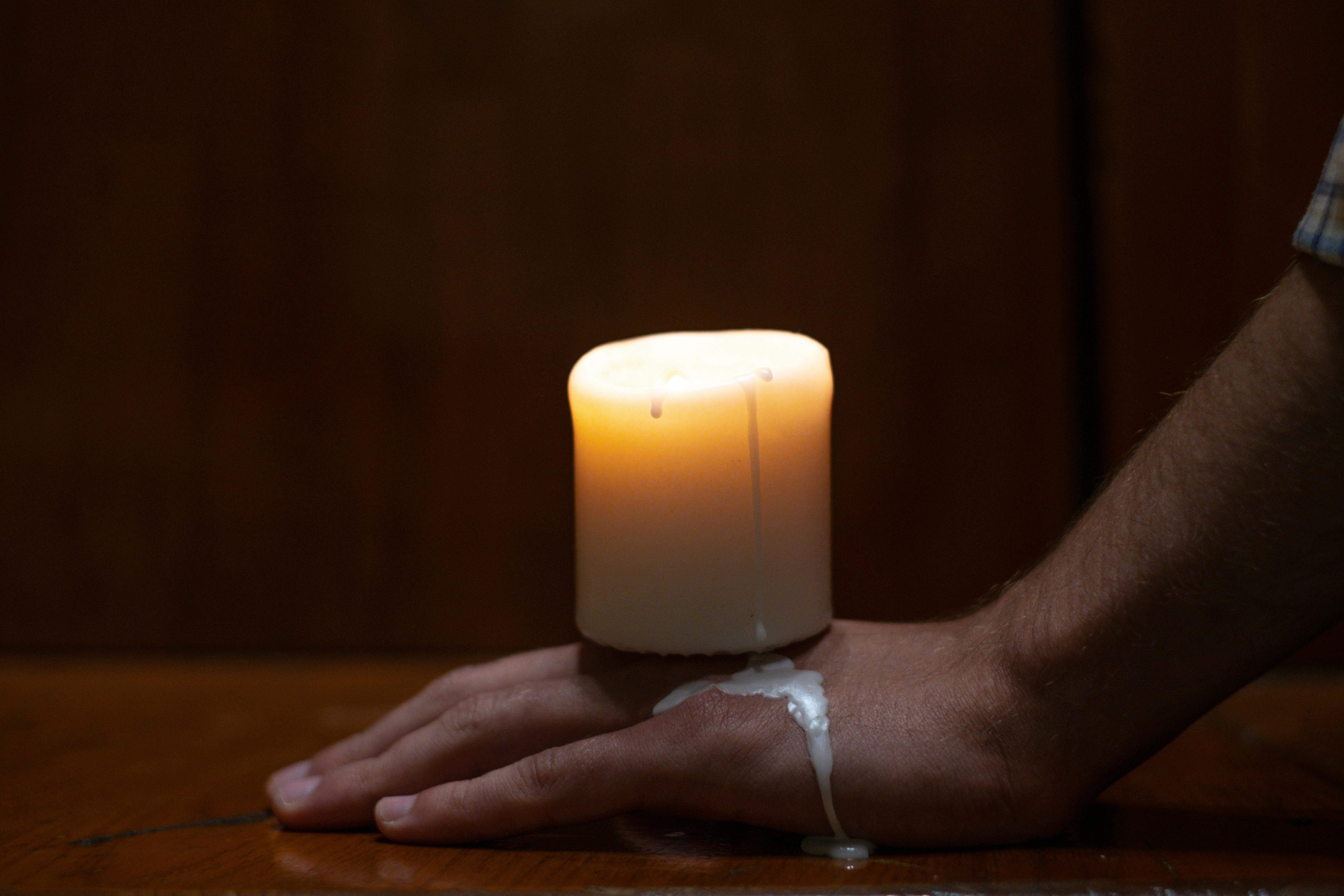 A Melting Candle on Persons Hand · Free Stock Photo