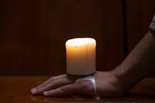 A Melting Candle on Persons Hand