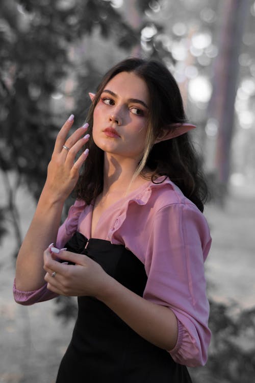 Young Woman with Elf Ears Posing in a Park