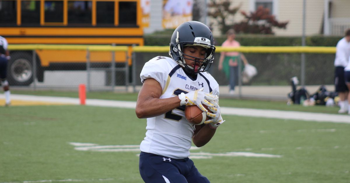 Athletic tight end catching a pass over a defender