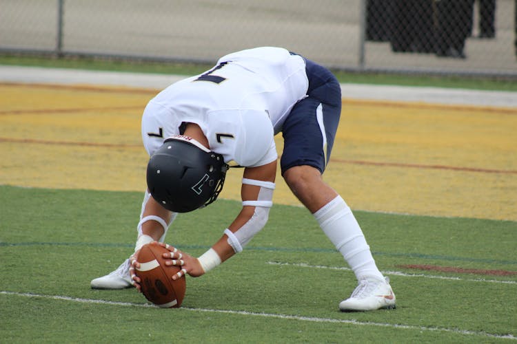 Football Player Holding Football