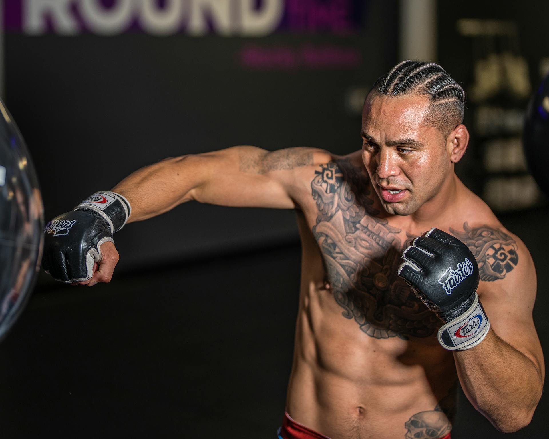 Photo of a Man Training with Punching Bag