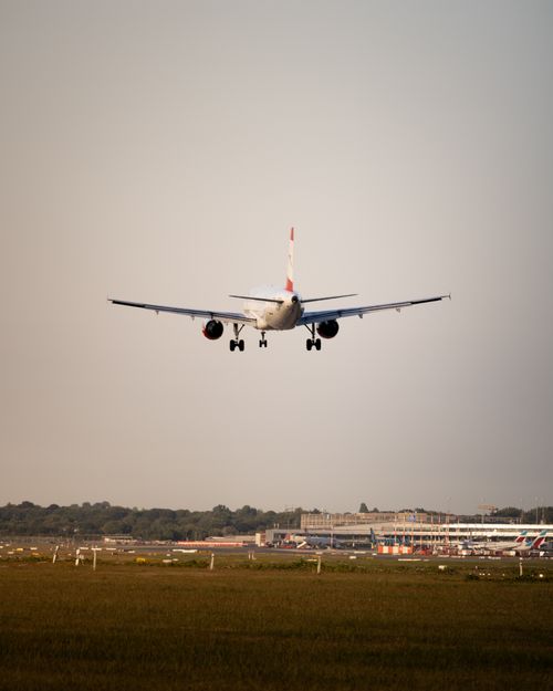 Free A passenger jet approaches its landing on a runway against a clear sky. Stock Photo