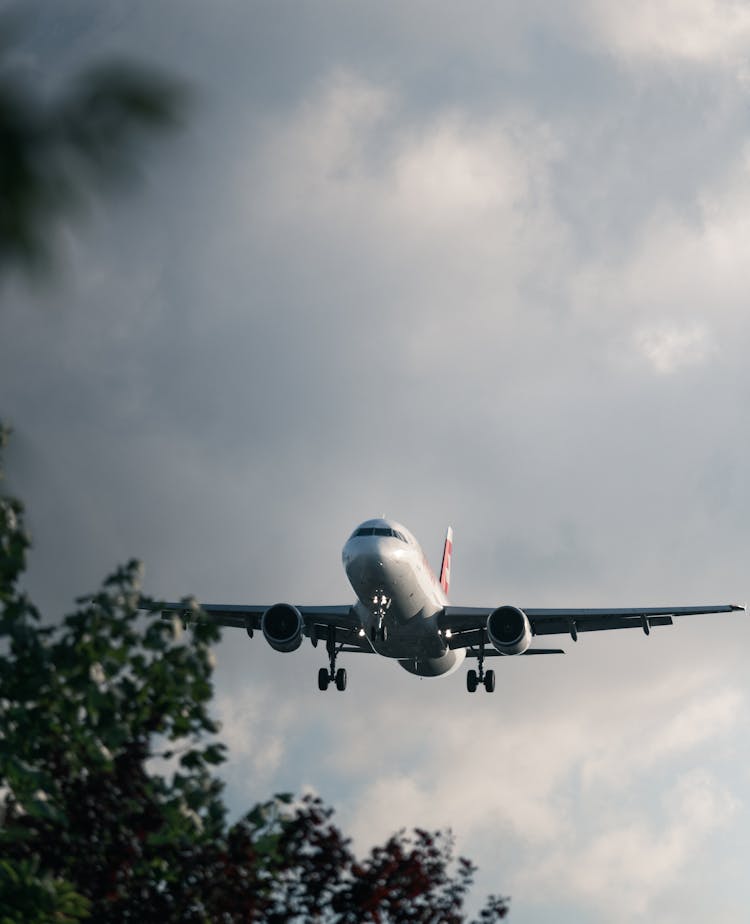 Airplane Flying On A Gloomy Sky 