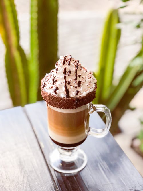 Photo of a Cup of Coffee with Whipped Cream on the Top