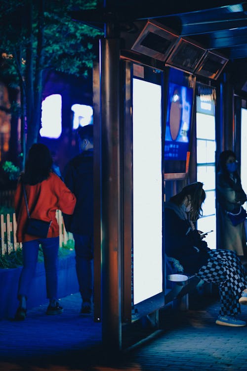 People Around Bus Stop at Night