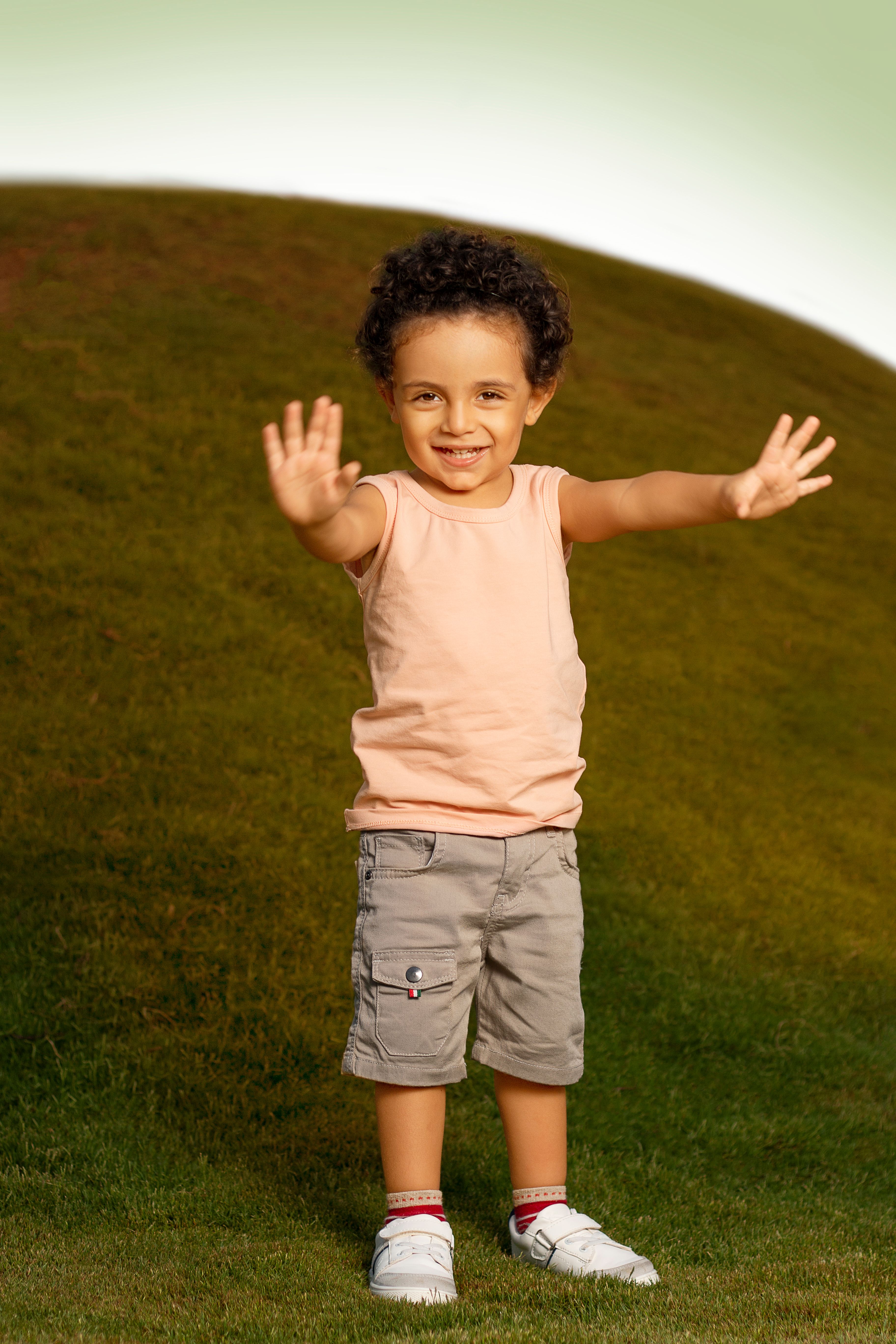 Happy young boy smiling on a sunny day, enjoying outdoor play.