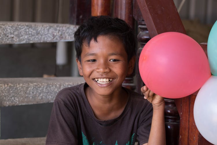 Smiling Boy With Balloons