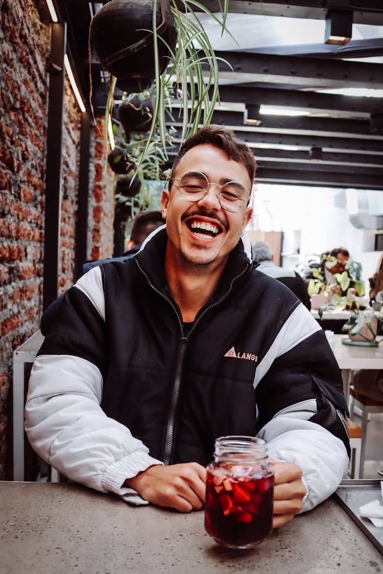 Smiling Man With Drink In Jar