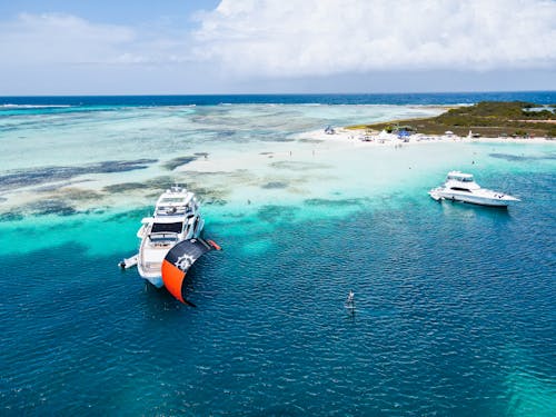 Idyllic Photo of a Tropical Island with Boats and a Kite Surfer