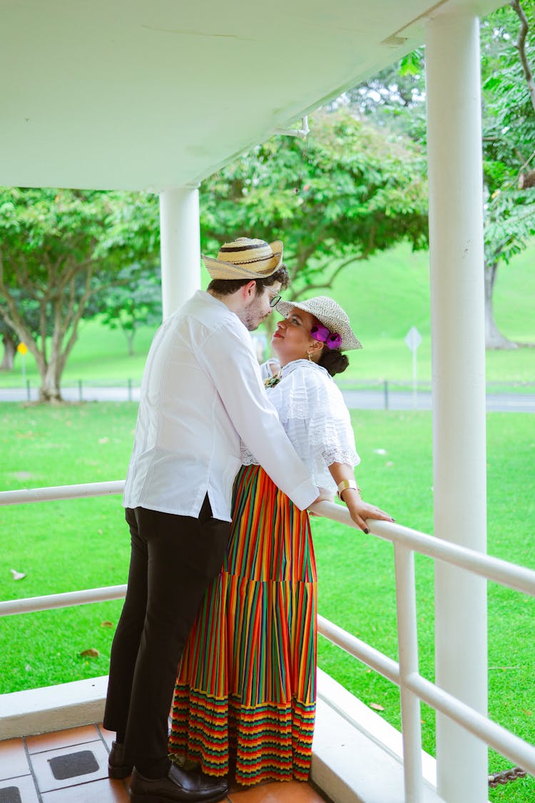 Man Kissing A Woman On The Porch 