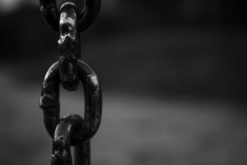 A close-up of heavy steel chain links holding firm, the picture of a streak before it snaps.