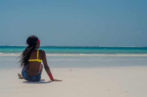Photo of Woman Sitting on Seashore