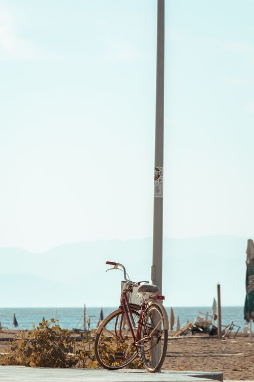 Free A vintage bicycle leans against a pole by Velipojë beach, Albania, on a bright summer day. Stock Photo