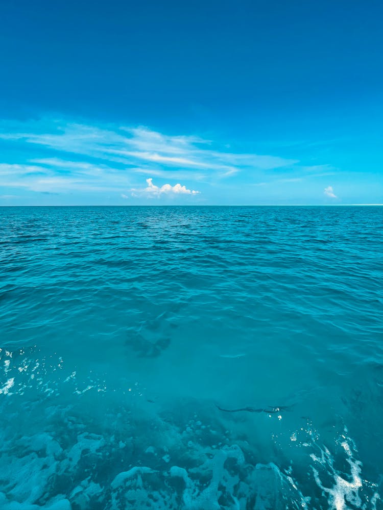 Blue Sea And Clouds Over