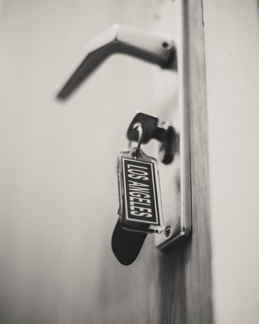 Black and white image of door lock and key with Los Angeles label, symbolizing security.