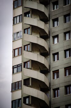 Close-up view of a high-rise building facade featuring a distinctive spiral staircase design.