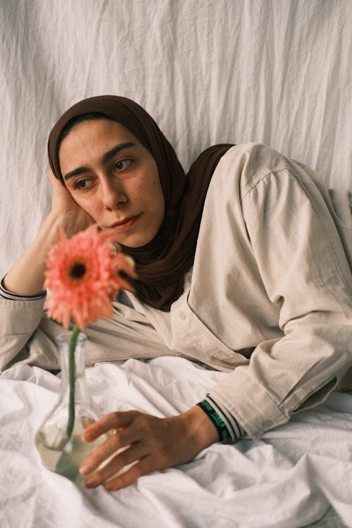 Woman in Hijab Lying Down with Flower
