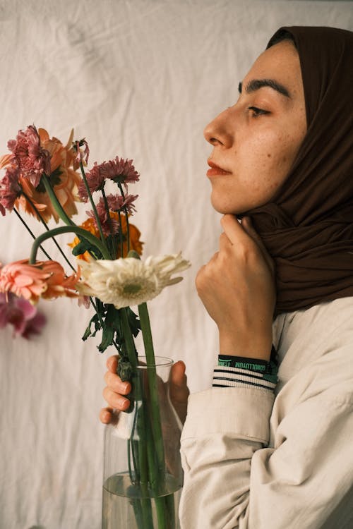 Woman Holding Vase with Flowers