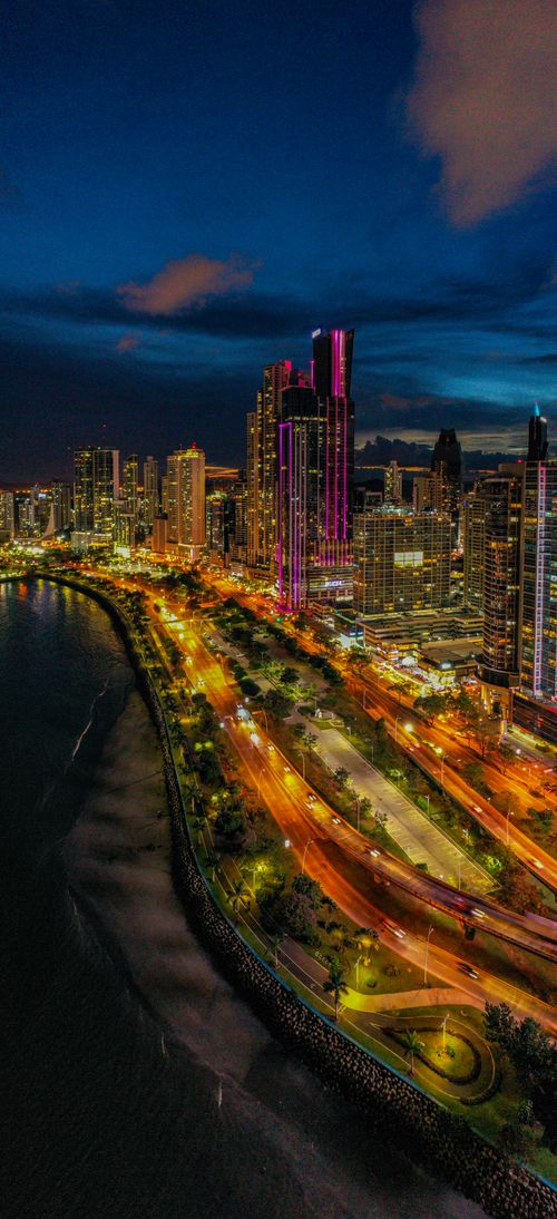 Free Dazzling aerial view of Panama City's illuminated skyline and waterfront at night. Stock Photo