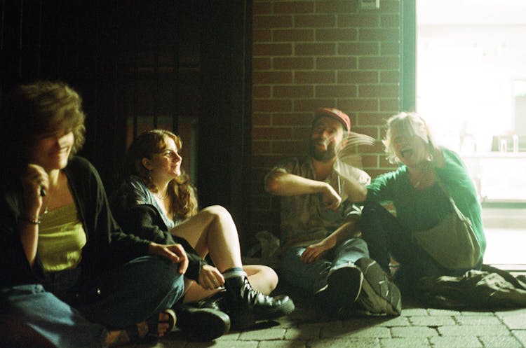 People Sitting On The The Ground Together