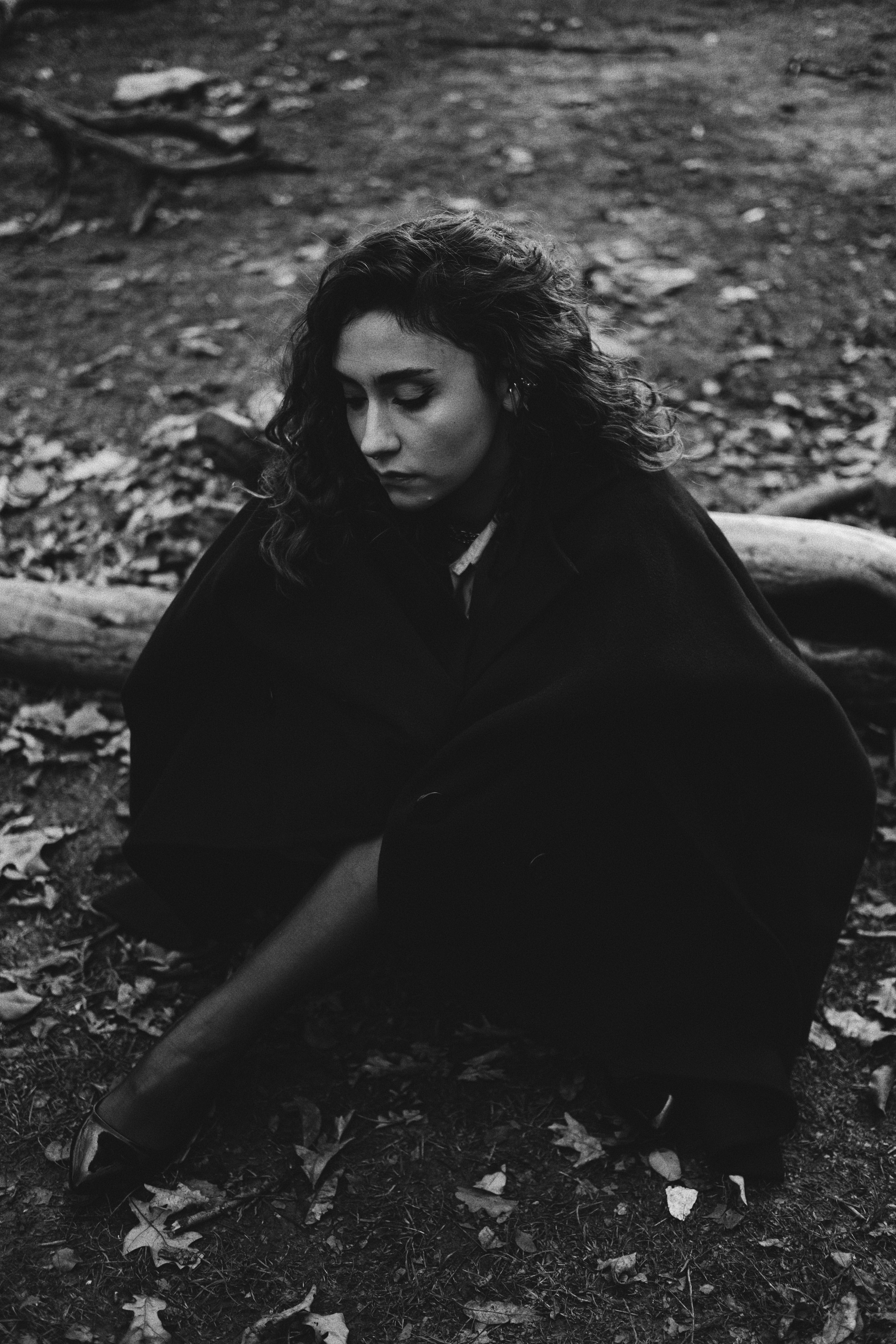 Grayscale Photo of a Woman with a Blazer Sitting on the Ground · Free ...