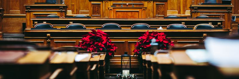 Spacious and elegant wooden courtroom with empty seats, located in Bern, Switzerland.