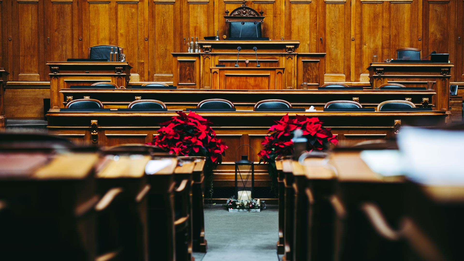Spacious and elegant wooden courtroom with empty seats, located in Bern, Switzerland — what does sustained mean in court