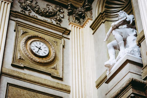 Close-up of a Clock and Statue on the Parliament Building in Bern, Switzerland