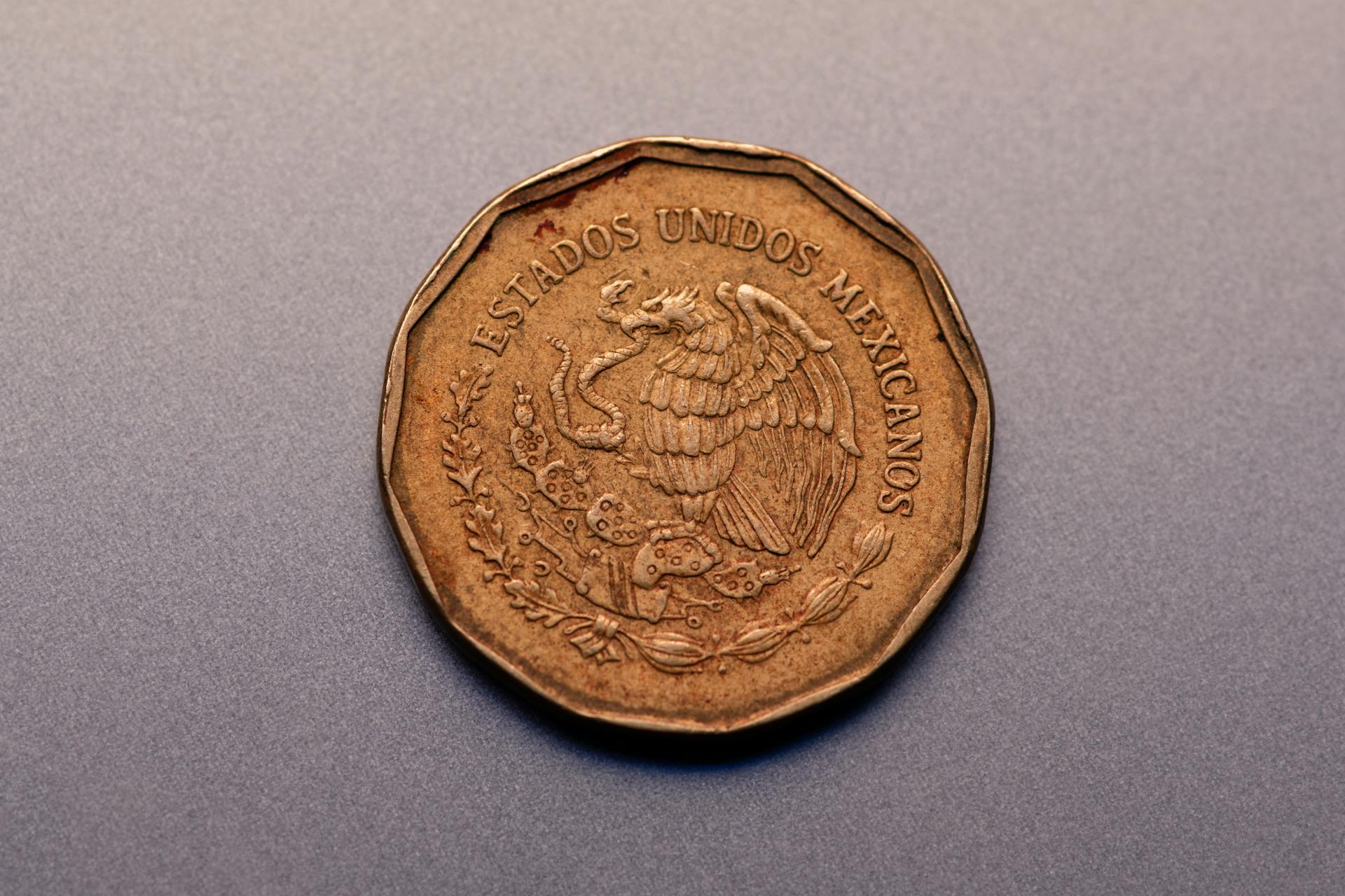 Mexican Gold Coin on Gray Surface