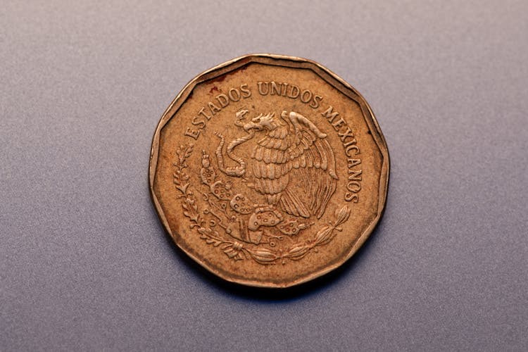 Mexican Gold Coin On Gray Surface