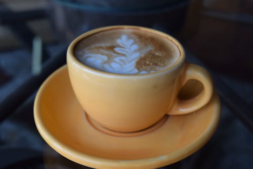 咖啡拿铁咖啡上棕色陶瓷杯和盘