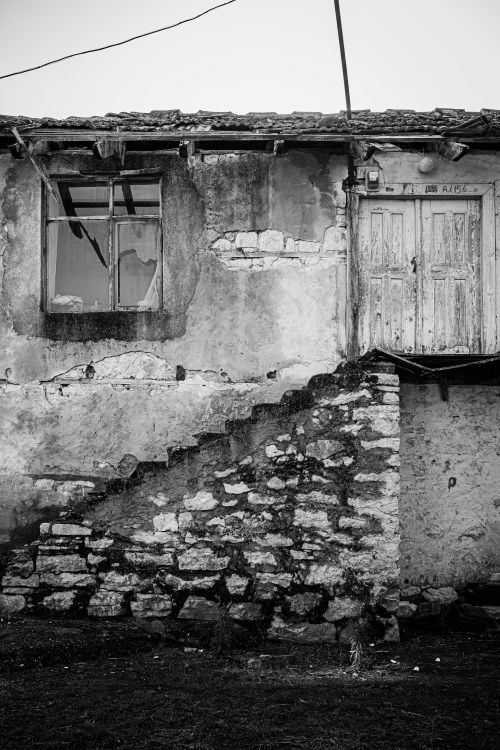 Free A weathered stone house captured in artistic black and white, showcasing rustic charm. Stock Photo