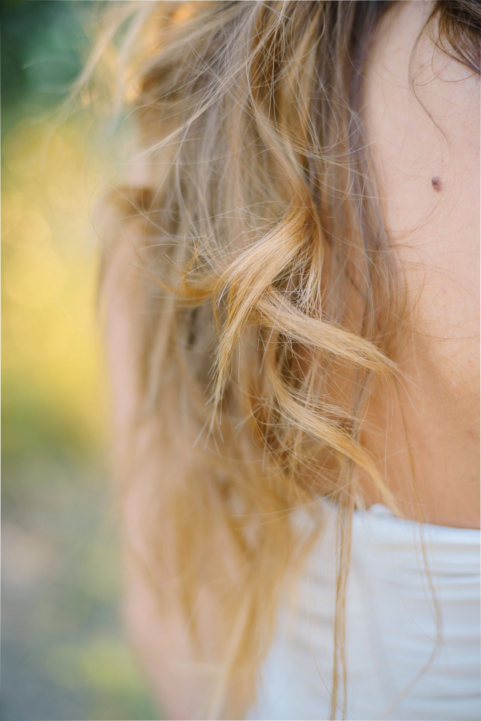 Close-up of soft, curly hair strands in natural light showing individual curl texture